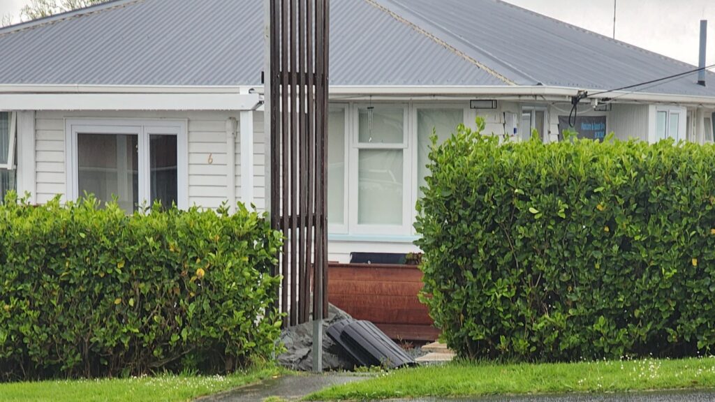 Salon is in a white weatherboard building with a grey iron  roof